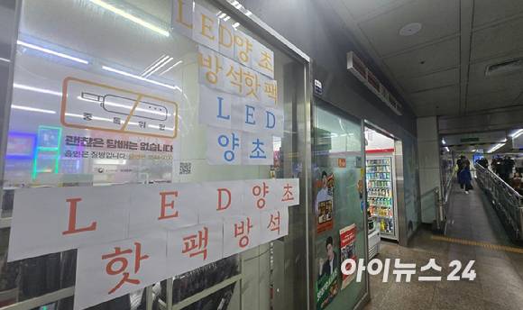 서울 광화문 한 편의점에 LED양초, 핫팩, 방석 등을 판매한다는 종이가 붙어 있다. [사진=진광찬 기자]