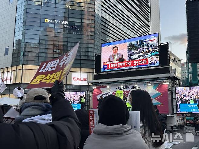 [대전=뉴시스] 김도현 기자 = 14일 오후 대전 서구 둔산동 은하수네거리 일대에서 열린 윤석열 대통령 퇴진 집회에서 탄핵소추안 표결 결과가 가결로 나오자 시민들이 환호성을 지르고 있다.2024.12.14. kdh1917@newsis.com