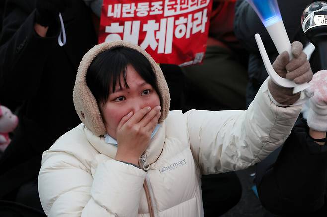 14일 내란죄 피의자 윤석열 대통령의 탄핵소추안이 가결되자 국회 앞에서 ‘윤석열 탄핵’을 외치던 시민이 기뻐하며 눈물을 흘리고 있다. 김혜윤 기자 unique@hani.co.kr