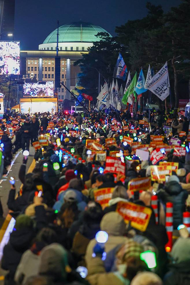 Protesters demand the impeachment of President Yoon Suk Yeol near the National Assembly in western Seoul on Dec. 10. [YONHAP]