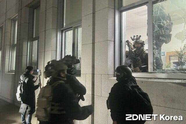 12월3일 비상계엄 선포 당시 국회 본청 앞. 계엄군이 유리창을 깨고 건물 내로 진입하고 있다.