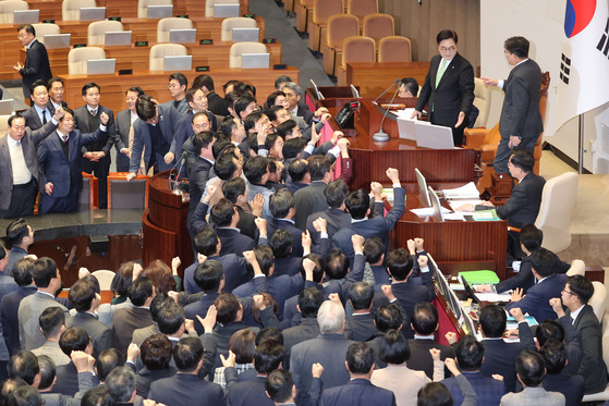 우원식 국회의장이 지난 27일 오후 국회 본회의에서 한덕수 국무총리 탄핵소추안 가결 의결정족수에 대한 설명(재적의원 과반수 찬성)을 하자, 국민의힘 권성동 대표 권한대행 겸 원내대표가 의장석에 올라가 항의하고 있다. 〈사진=연합뉴스〉