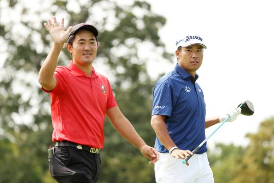 Takumi Kanaya, left, and Hideki Matsuyama walk off a tee during a practice round prior to the U.S. Open Championship on Sept. 15, 2020 at Winged Foot Golf Club in Mamaroneck, New York. [GETTY IMAGES]
