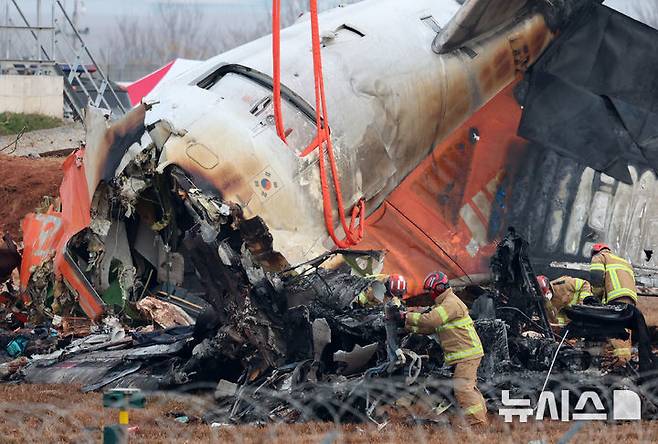 [무안=뉴시스] 이영환 기자 = 30일 오전 전남 무안국제공항 제주항공 여객기 사고 현장에서 소방대원들이 수색작업을 하고 있다. 2024.12.30. 20hwan@newsis.com