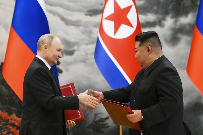Russian President Vladimir Putin and North Korean leader Kim Jong-un exchange documents during a signing ceremony of a new partnership in Pyongyang, North Korea, on June 19, 2024.  (File Photo - Kremlin Pool Photo via AP)