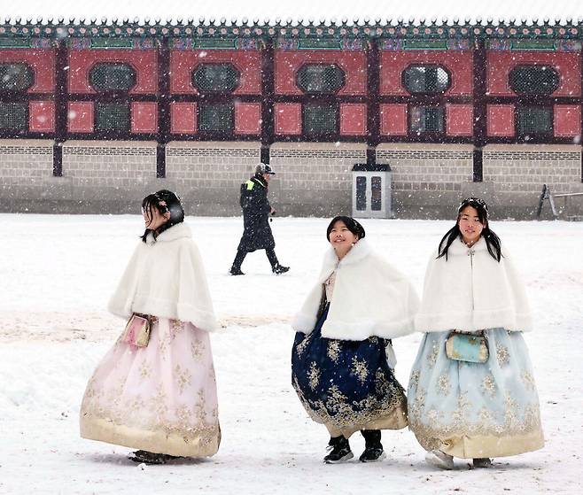 서울 경복궁을 방문한 외국인들이 한복을 입고 함박눈을 즐기며 걷고 있습니다. 흰 눈으로 새하얗게 변한 궁궐의 모습이 이들에게 서울의 아름다운 풍경으로 오래도록 남길 바랍니다.  한주형 기자