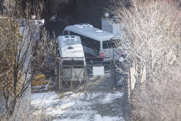 서울 용산구 한남동 대통령 관저에서 경호처 직원이 철조망이 쳐진 쪽문을 버스로 벽을 치고 있다. 연합뉴스