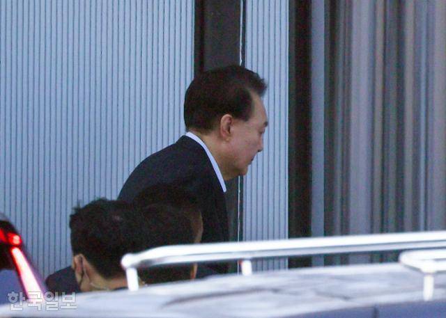 내란 우두머리 혐의로 체포된 대통령 윤석열이 15일 경기 과천 고위공직자범죄수사처 청사 정문에 마련된 포토라인을 피해 후문으로 들어가고 있다. 왕태석 선임기자