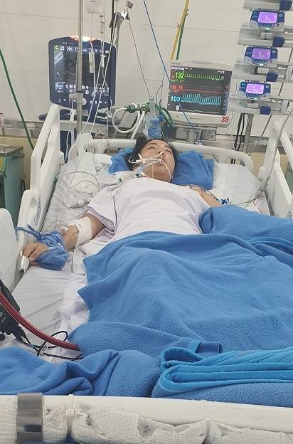 Kim lies unconscious in a hospital bed following a sudden brain hemorrhage. (Courtesy of Kim)
