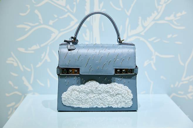 Tempete Le Chant de l'Orage, inspired by Surrealist artist Rene Magritte's (1898-1967) painting of the same title, also known as ″Song of the Storm″ (1937) in English. This model is adorned with hand-embroidered embossed pearls. [DELVAUX]
