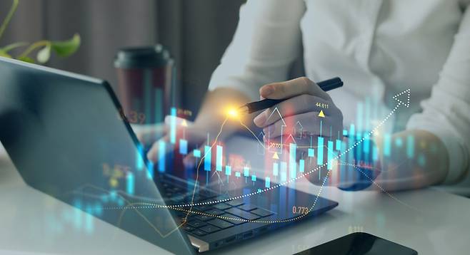 Business person pointing growing virtual hologram of statistics, graph and chart.Business strategy development and growing growth plan. Investment of growth on currency rate