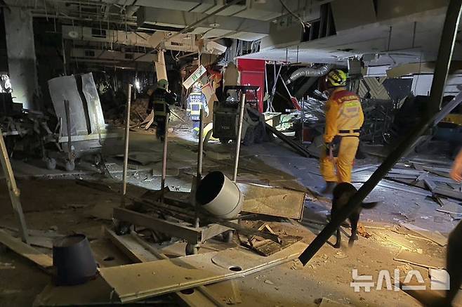 [타이중=AP/뉴시스] 대만 국가소방청이 제공한 사진에 13일(현지 시간) 대만 타이중의 신광 미츠코시 백화점에서 폭발이 일어나 소방관들이 현장을 조사하고 있다. 현지 당국은 푸드코트 공사 중이던 12층에서 폭발이 일어나 최소 4명이 숨지고 31명이 부상했다고 밝혔다. 2025.02.13.