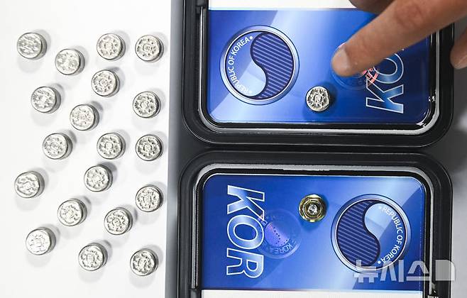 [수원=뉴시스] 김종택 기자 = 자동차 등록번호판 봉인제도 폐지를 하루 앞둔 20일 경기도 수원도시공사 번호판제작소에서 관계자가 기존 스테인리스 마개로 봉인된 번호판(사진 위)과 마개를 제거한 뒤 너트로 고정한 번호판을 보여주고 있다.도난, 번호판 위·변조 방지를 위해 1962년 시행된 자동차 등록번호판 봉인제도는 자동차관리법 일부 개정에 따라 등록번호판에 봉인을 부착하지 않고 운행할 수 있다. (공동취재) 2025.02.20. photo@newsis.com