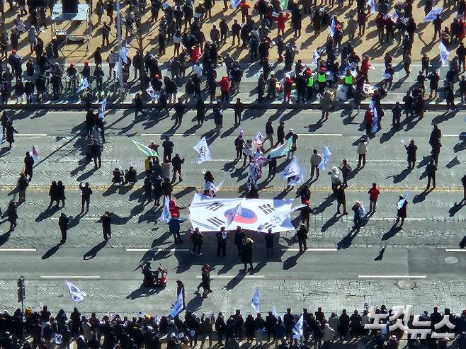 세이브코리아의 집회에 참석한 시민들이 대형 태극기를 들고 있다. 인상준 기자