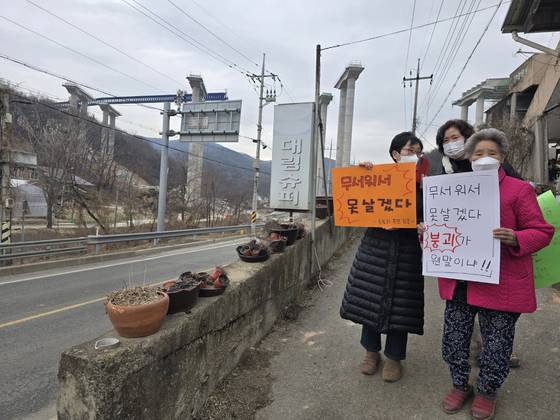세종포천고속도로 교량 붕괴 현장에서 불과 수십미터 떨어진 마을에 거주하는 충남 천안 입장면 도림리 주민들이 지난달 28일 관계기관 합동 현장감식을 하는 동안 피켓 시위를 하고 있다. 손성배 기자