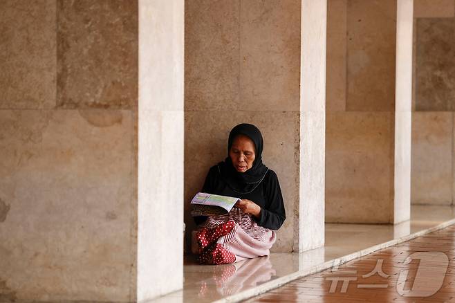 인도네시아 무슬림 여성이 자카르타의 이스티클랄 대모스크에서 라마단 기간 중 코란을 낭송하고 있다. ⓒ 로이터=뉴스1