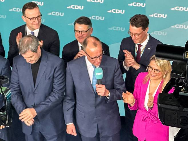 Leader of the Christian Democratic Union of Germany (CDU), Friedrich Merz, center, a candidate for German chancellor, delivers an address at the headquarters of the CDU in Berlin, on Feb. 23. [YONHAP]