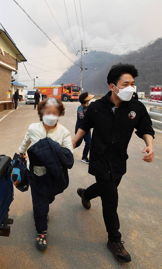22일 경북 의성군에서 발생한 산불이 이틀째 진화되지 않은 가운데 23일 단촌면 상화리 주민들이 산불을 피해 안전한 곳으로 대피하고 있다. 의성=뉴스1