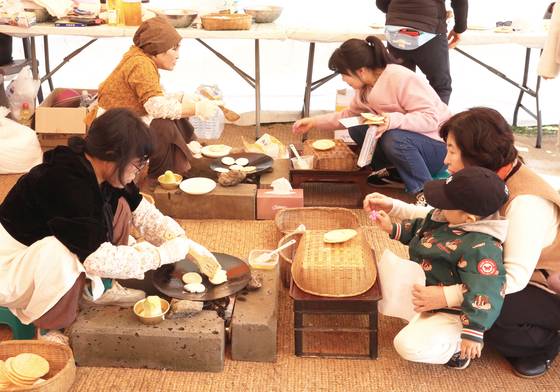 서귀포 봄맞이 축제 장면. 서귀포 주민이 화전을 부쳐 나눠 먹고 있다.