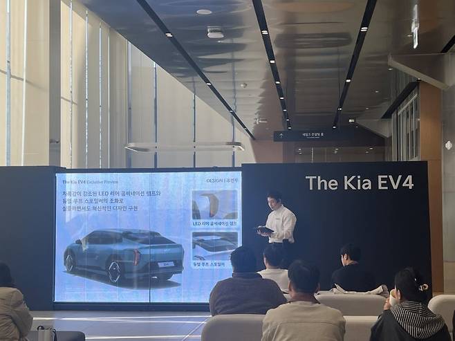 지난 29일 기아 인천 플래그십 스토어에서 개최된 EV4 체험 행사에 고객들이 참여해, 도슨트 직원의 차량 설명을 듣고 있다. 사진=이상진
