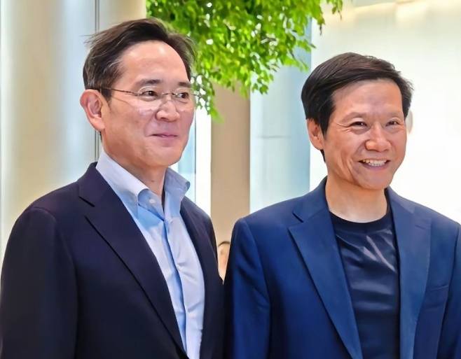 [서울=뉴시스] 이재용 삼성전자 회장(왼쪽)이 22일 샤오미 전기차 공장에서 레이 쥔 샤오미 회장을  만나 기념촬영을 하고 있다. (사진=중국 샤오미 웨이보 캡처) 2025.03.23