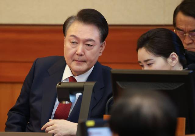 ▲윤석열 대통령이 2월 13일 서울 종로구 헌법재판소에서 열린 윤석열 대통령 탄핵심판 8차 변론에서 변호인단과 대화하고 있다. ⓒ연합뉴스