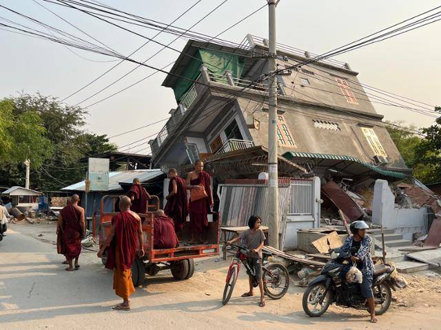 지난달 28일 발생한 미얀마 규모 7.7 강진의 '진앙'으로 꼽히는 사가잉에서 3일 한 건물이 반쯤 기울어져 있다. 붕괴 위험이 커지자 인근에 머물던 스님들이 차량을 타고 다른 곳으로 이동하고 있다. 사가잉=허경주 특파원