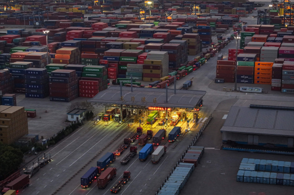 8일 중국 동부 장쑤성 난징의 한 항구에서 트럭과 컨테이너가 선적을 기다리고 있다. 난징 AFP  연합뉴스