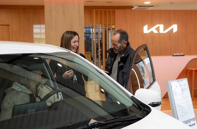 25일(현지 시각) 스페인 바르셀로나에 위치한 기아 딜러점 '기아 인테그랄 카'에서 영업직원이 고객에게 차량을 소개하고 있다. / 기아 제공