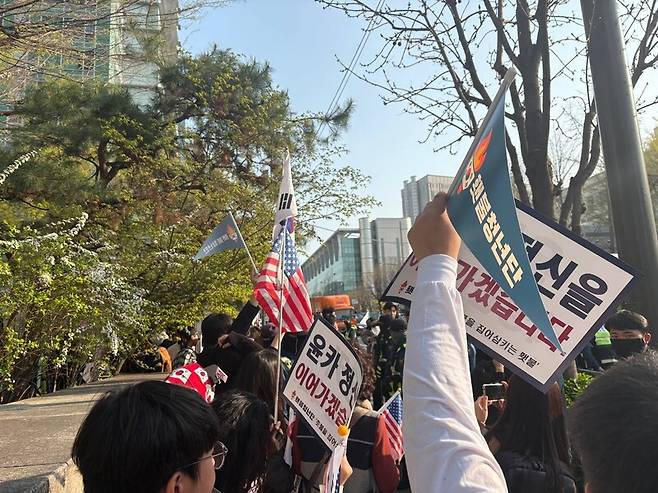 윤석열 전 대통령 지지자들이 윤 전 대통령 사저인 서울 서초동 아크로비스타 앞에서 성조기와 손팻말을 흔들고 있다. 임재희 기자.