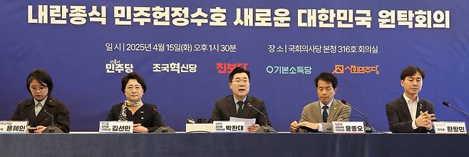 박찬대 더불어민주당 당 대표 직무대행 겸 원내대표(가운데)를 비롯한 야 5당 대표 및 권한대행들이 15일 국회에서 열린 ‘내란종식 민주헌정수호 새로운 대한민국 원탁회의’를 하고 있다. 연합뉴스
