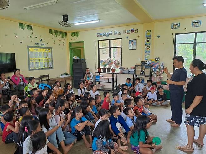 오태훈(오른쪽 두 번째) 장로가 현마리아 집사의 학창시절 초등학교를 방문해 학생들에게 복음을 전하는 모습. 국제순복음교회 제공