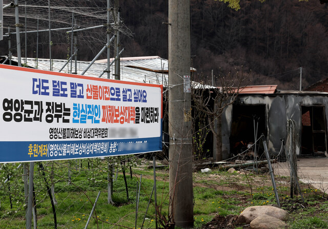 20일 오후 산불로 다수의 인명피해가 발생한 영양군 석보면 화매리에 현실적인 피해보상대책을 요구하는 현수막이 걸려 있다. /이용선기자 photokid@kbmaeil.com