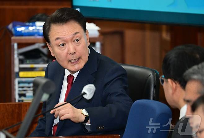 12·3 비상계엄을 선포해 내란 우두머리 혐의로 재판에 넘겨진 윤석열 전 대통령이 21일 오전 서울 서초구 서울중앙지법 417호 법정에 앉아 변호인단과 대화를 하고 있다. 2025.4.21/뉴스1 ⓒ News1 사진공동취재단