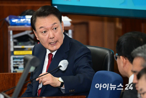 윤석열 전 대통령이 21일 서울 서초동 서울중앙지법에서 열린 내란 우두머리 혐의 형사재판 2번째 공판에 출석해 변호인단과 대화를 하고 있다. [사진=사진공동취재단]