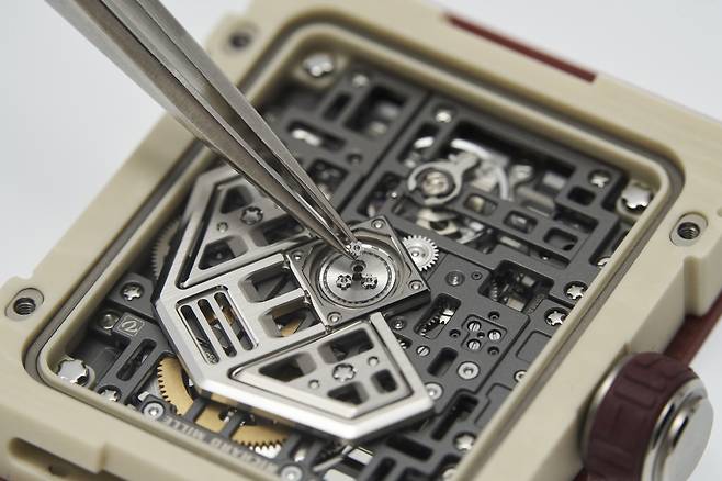 백케이스로 드러난 무브먼트. 플래티넘과 티타늄으로 만든 로터 디자인이 미래지향적이다. 사진 리차드 밀