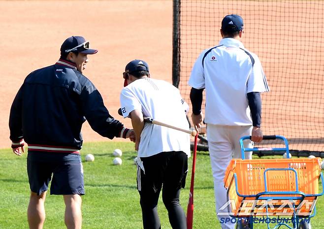 그라운드 정리 중인 김민석의 손을 잡아 끄는 전준우