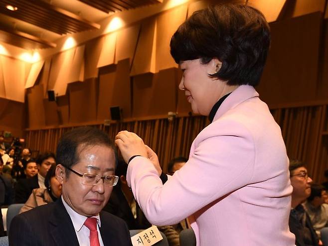 홍준표 국민의힘 대선 경선 후보의 배우자 이순삼 여사가 지난 2019년 서울 영등포구 여의도 The-K타워 그랜드홀에서 열린 홍 후보의 자서전 '당랑의 꿈' 출판기념회에서 홍 후보의 머리를 손질해주고 있다. ⓒ뉴시스
