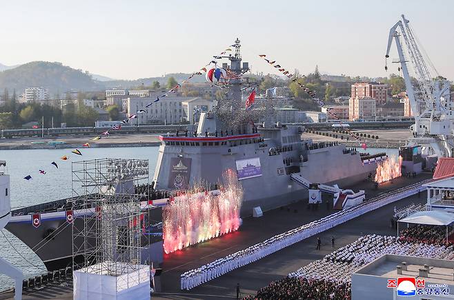 The Choe Hyon is seen docked amid confetti, troops, and military fanfare during its official unveiling ceremony in Nampho on Friday. (Yonhap)