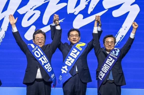 더불어민주당 호남 경선 시작 - 이재명(왼쪽부터), 김경수, 김동연 더불어민주당 대선 경선 후보가 26일 광주 서구 김대중컨벤션센터에서 열린 ‘제21대 대통령선거 후보자 선출을 위한 호남권 합동연설회’에서 함께 손을 들어 인사하고 있다. 2025.4.26 [공동취재] 광주 연합뉴스