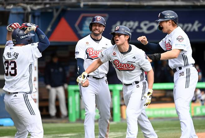 두산 오명진이 27일 롯데와 홈 경기에서 선제 결승 만루포를 터뜨린 뒤 동료들과 기뻐하고 있다. 두산