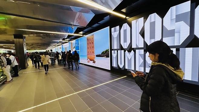 일본 오사카·간사이 만국박람회 행사장 지하철역인 유메시마역에 관람객 환영 문구가 적힌 대형 전광판이 보인다.