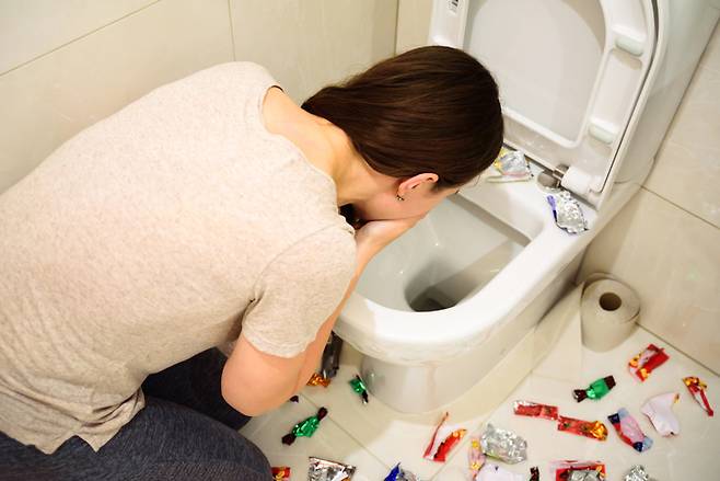 폭식증 환자가 짧은 시간에 많은 음식을 먹은 뒤 토하고 있다. 성인 여드름 환자가 폭식증, 거식증 등 섭식장애를 일으킬 위험이 높다는 연구 결과가 나왔다. [사진=게티이미지뱅크]