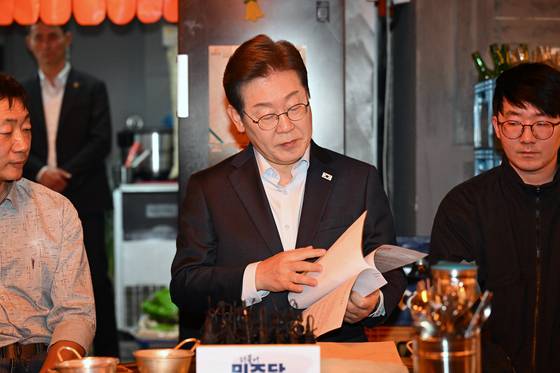 이재명 더불어민주당 대선 후보가 1일 서울 종로구의 한 음식점에서 열린 비전형 노동자 간담회에 참석해 노동자들이 전달한 자료를 확인하고 있다. 대법원 전원합의체는 이날 이 후보에게 무죄를 선고한 원심판결을 파기하고 사건을 서울고법으로 돌려보냈다. 김성룡 기자