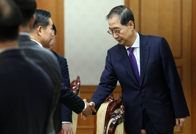 ▲ 한덕수 대통령 권한대행 국무총리가 1일 서울 종로구 정부서울청사에서 열린 안보관계장관회의에 참석하며 신원식 국가안보실장과 악수하고 있다. [연합뉴스]