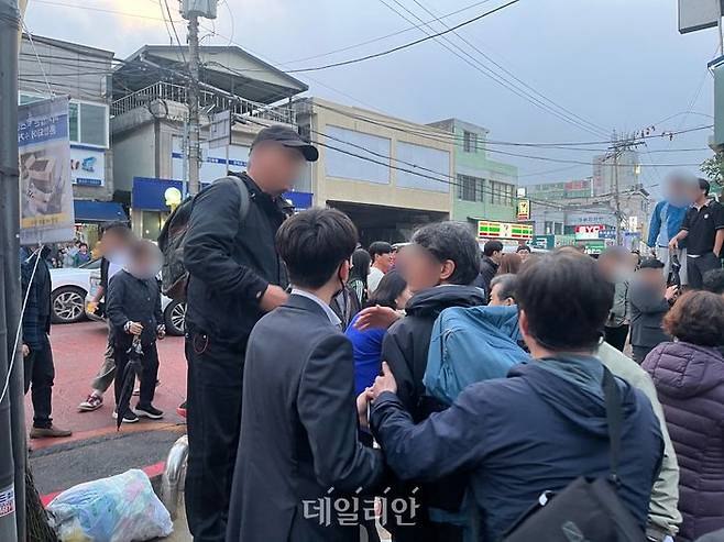 한 남성이 지나가는 이재명 후보를 크게 부르며 "모든 공직자는 (범죄) 의혹이 있으면 안 된다"고 목소리를 높이며 지지자들과 실랑이를 벌이는 모습 ⓒ데일리안 김수현 기자