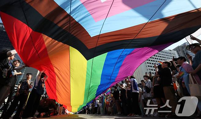 1일 오후 서울 종각역 일대에서 열린 '2024 서울퀴어문화축제'를 찾은 시민들이 무지개 깃발이 펼쳐지자 환호하고 있다. 2024.6.1/뉴스1 ⓒ News1 이동해 기자