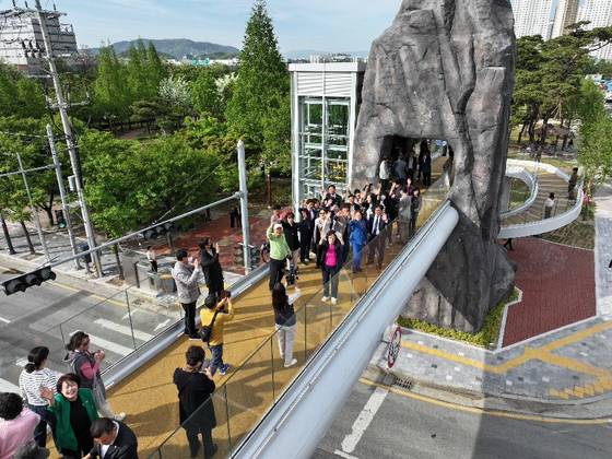 최근 대구 달서구 선돌공원과 선돌마당공원 사이에 놓인 선돌보도교 위에서 방문객들이 촬영용 드론을 향해 손을 흔들고 있다. [사진 달서구]