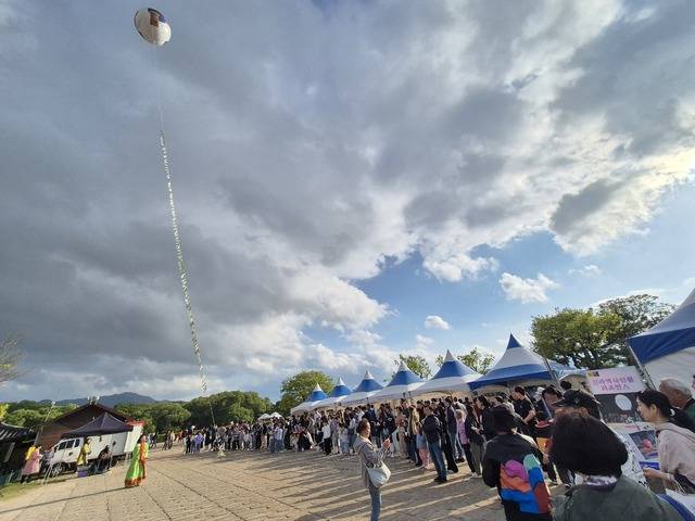 경북문화관광진흥원이 지난 3일 실시한 세계유산 활용프로그램에 참여한 600여명이 소원지를 단 소망풍선을 띄우고 있다. 경북문화관광진흥원 제공