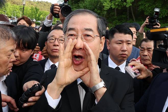 지난 2일 오후 광주 북구 국립 5·18 민주묘지를 찾은 한덕수 전 총리가 광주비상행동 등 시민·사회단체 관계자들의 반발에 가로 막히자 "저도 호남 사람"이라며 참배를 호소하고 있다. 연합뉴스